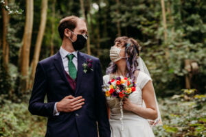Couple wearing masks in the woods
